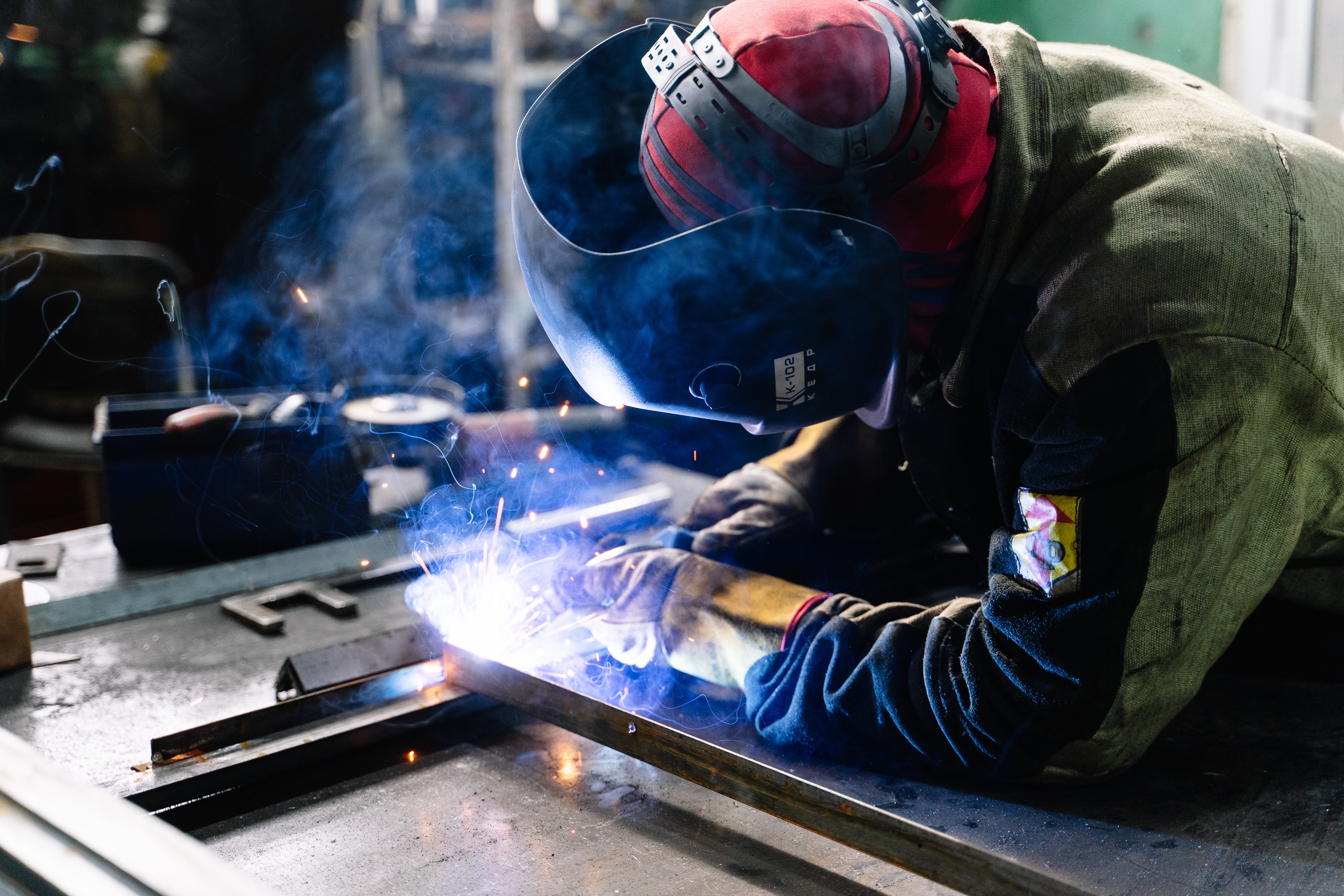 man-welding-metal-bars-2381463